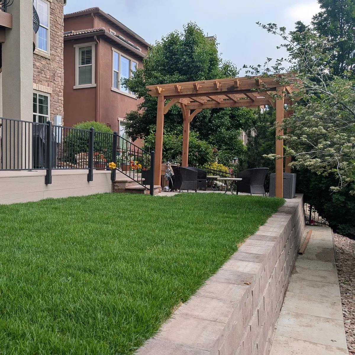 Services retaining wall pergola deck grass